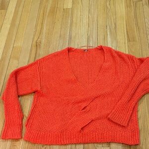 Free People V neck sweater twist design in the front.